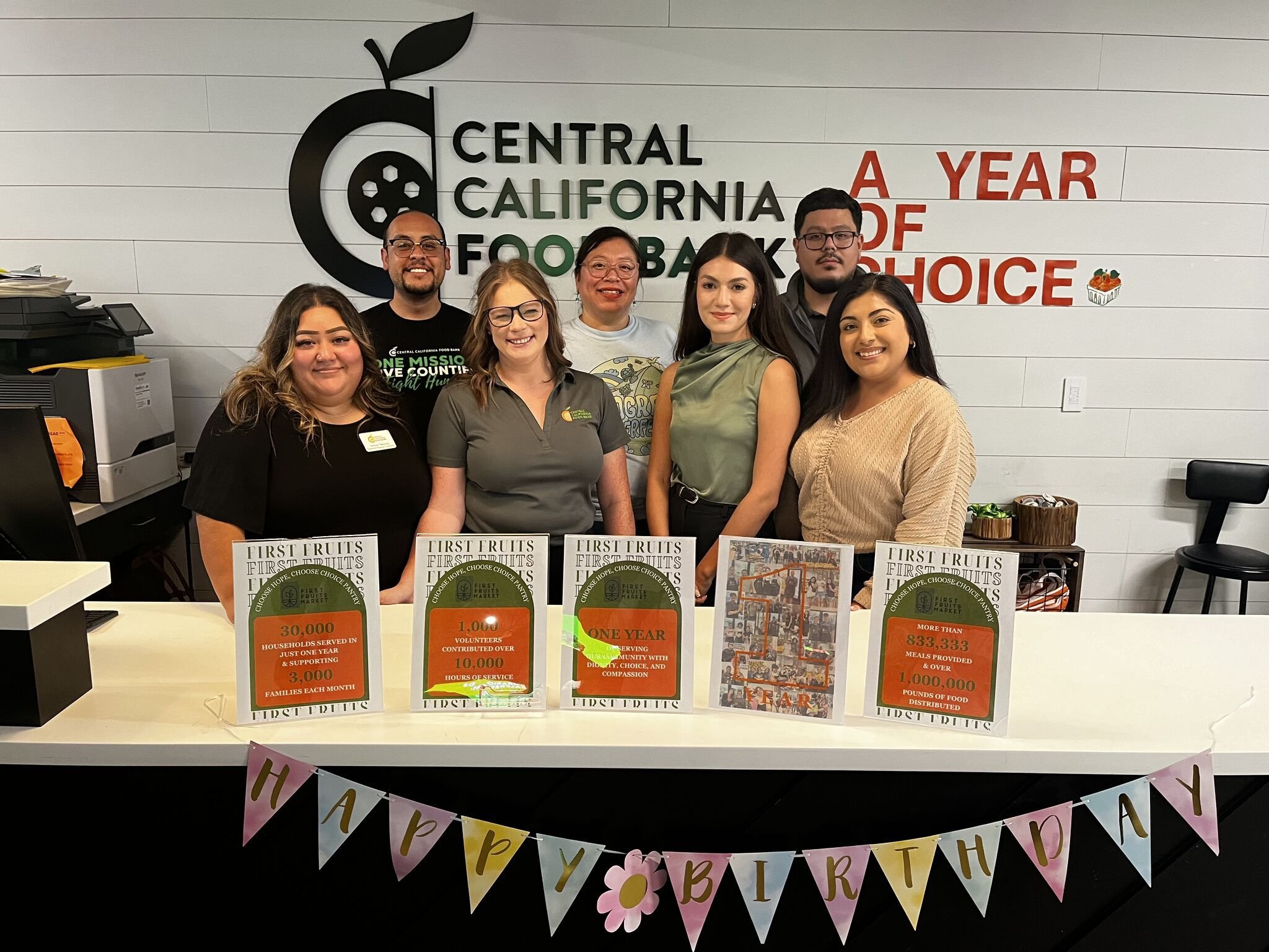 Community nutrition center volunteers preparing healthy food packages for distribution representing the food assistance programs at California Nutrition Center